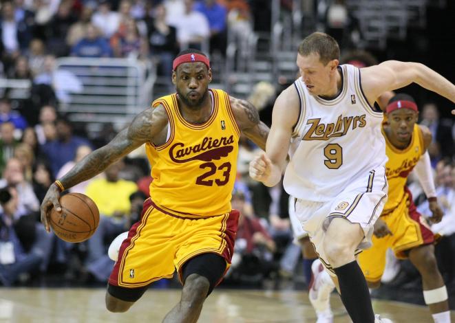 In this action shot, Darius Songaila tries to stop LeBron James.